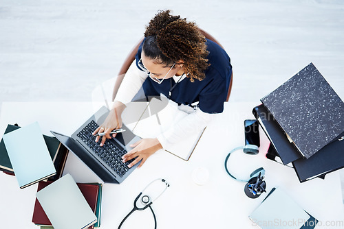 Image of Top view, laptop or nurse in hospital research, education studying or university books learning for medical student. Above, woman or healthcare worker on technology in scholarship medicine internship