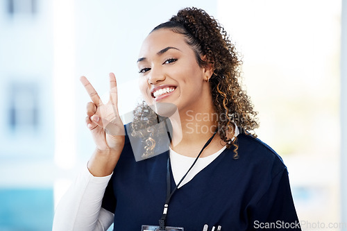 Image of Doctor, portrait and peace sign hands in hospital wellness, medicine trust or medical support of life insurance, help or vote. Smile, happy and nurse with number gesture in healthcare or woman emoji