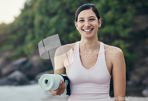 Image of Woman, yoga and fitness portrait in nature while outdoor for exercise, training and workout. Happy model person with mat for zen, peace and holistic time for health and wellness with beach pilates