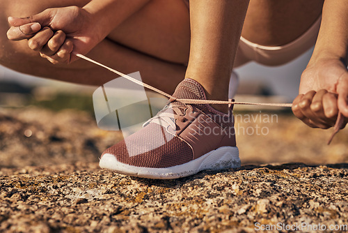 Image of Fitness, hands and tie shoes in nature to start running, workout or training. Sports, wellness and female or woman tying sneaker laces or footwear to get ready for exercising, cardio or jog outdoors.