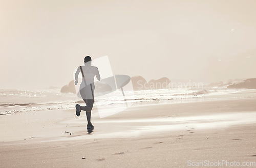 Image of Beach, back and woman running at sunset for health, fitness and wellness outdoors alone. Sports, training and female athlete or runner on workout, exercise or cardio, jog or exercising by seashore.