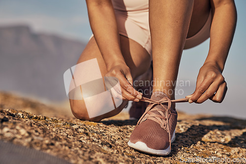 Image of Hands, hiking and tie shoes in nature to start running, workout or training. Sports, wellness and female or woman tying sneaker laces or footwear to get ready for exercising, cardio or hike outdoors.