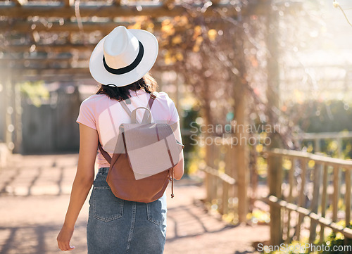 Image of Back, woman and travel for summer, outdoor and walking for sightseeing, break and vacation. Female tourist, student and lady with backpack, explore landmarks or enjoy holiday for adventure or journey