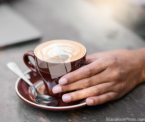 Image of Latte cup, hands on table with art for customer services, restaurant creativity and hospitality industry with inspiration. Cafe shop with person hand holding espresso, cappuccino or coffee drink