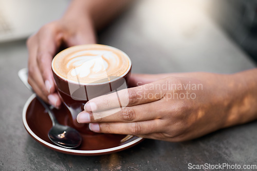 Image of Coffee cup, hands on table with art for customer services, restaurant creativity and hospitality industry with inspiration. Cafe shop with person hand holding espresso, cappuccino or latte drink