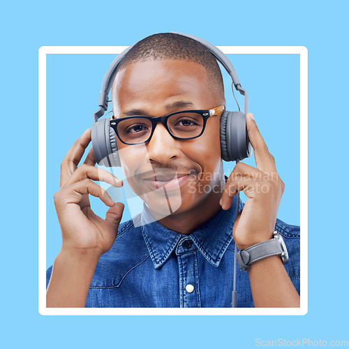 Image of Black woman, portrait and headphones for music with a smile for motivation with blue background. Face of African model person listening to podcast or audio with color wallpaper backdrop in studio