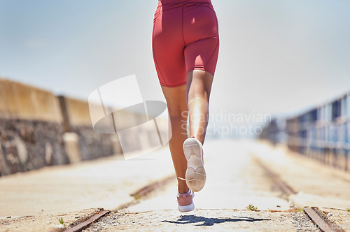 Image of Legs, running and fitness with runner outdoor, black woman athlete with cardio, speed and sneakers with run on bridge. Runner, active and sports with workout, exercise back view and mockup space