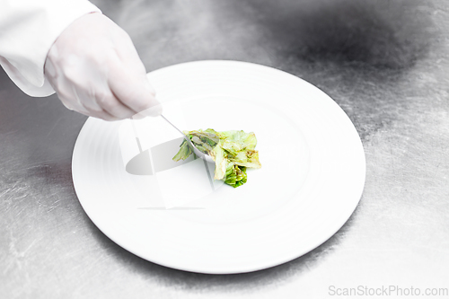 Image of Chef putting iceberg lettuce