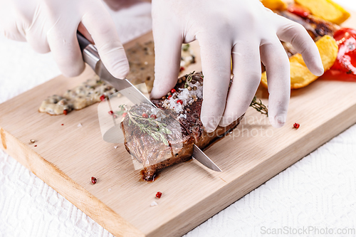 Image of Chef cutting beef steak