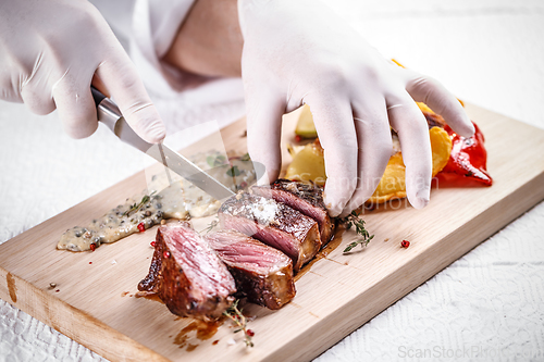 Image of Chef cutting beef steak