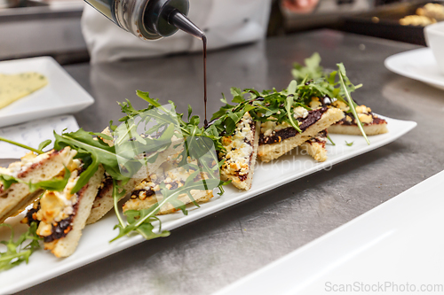 Image of Chef decorating appetizer dish