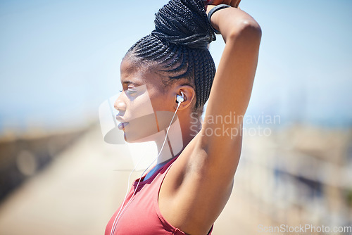 Image of Fitness, black woman and stretching outdoor with earphones for exercise, workout and training. Female athlete, focus and warm up to music for strong runner motivation, mindset goals and sports energy