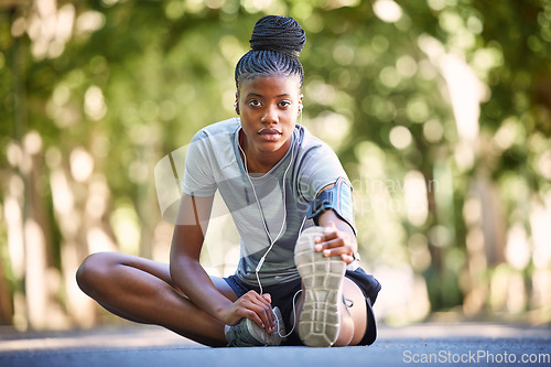 Image of Black woman, fitness and stretching legs for running, cardio exercise or workout preparation in nature. Portrait of African American female in warm up leg stretch ready for exercising run or training