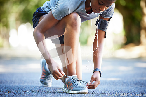 Image of Shoes, running and athlete tie laces ready to exercise, workout or fitness outdoors in a park by female training. Active, fit and closeup of person or runner preparing to jog for health and wellness