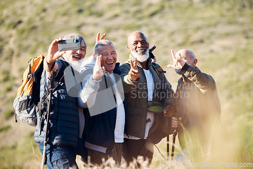 Image of Senior hiking, mountain selfie and elderly friends in nature on a walk with freedom in retirement. Healthy exercise, trekking and and outdoor adventure of old men group together with peace sign