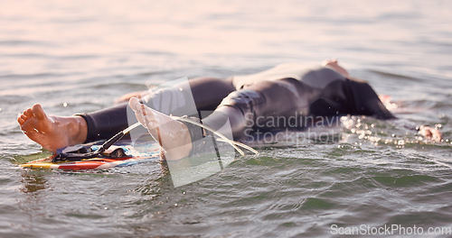 Image of Surfing, ocean and man float on water feeling relax, calm and freedom in nature. Sea, exercise and fitness of a young male on a surfboard with rest in tropical waters ready for surf and sports