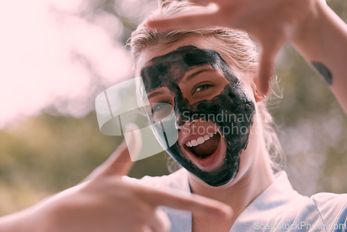 Image of Face mask, finger frame and portrait of a woman with a self care, natural and beauty morning routine. Happy, smile and female with a picture hand gesture doing a charcoal skincare facial treatment.