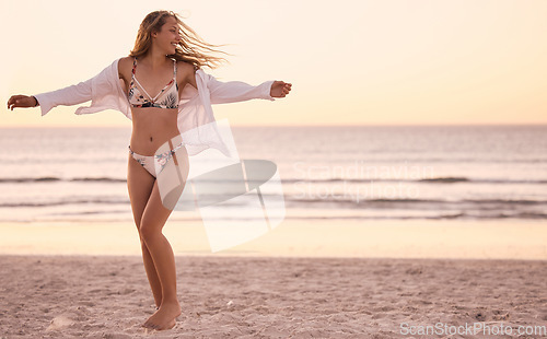 Image of Freedom, sunset and woman at the beach for swimming, energy and happiness at the ocean in Bali. Smile, relax and girl in a bikini at the sea for a holiday, stress free and enjoyment with mockup
