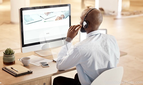 Image of Black man, call center and computer for tech support, communication and crm help at desk in office. Telemarketing expert, contact us and pc at desk for customer service for consulting on voip tech