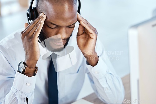 Image of Anxiety, burnout and headache by consultant worker, customer service and call center employee in office. Pain, mental health and depressed telemarking agent overworked and frustrated at the workplace