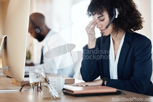 Image of Stress, anxiety and depression female call center agent frustrated and sad in an office or workplace. Headache, pain by customer service worker, employee or consultant feeling depressed