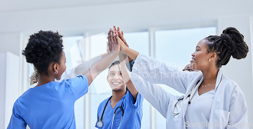 Image of Success, high five and teamwork with doctors in hospital cheering for celebration, support or goal. Medical, healthcare and medicine with group of people and gesture for achievement, target or winner