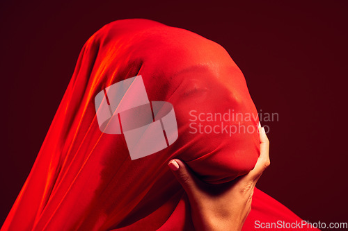 Image of Model, red fabric and hidden face for fashion, aesthetic and beauty by dark studio background. Gen z woman, cloth or silk veil for creativity, design and art with retro, vintage or creative clothes