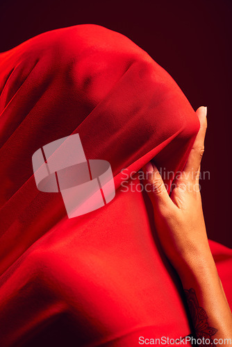 Image of Woman, red fabric and hide face for fashion, aesthetic and sensual with dark studio background. Gen z model, cloth or silk veil for creativity, vision and art with retro, vintage or creative clothes