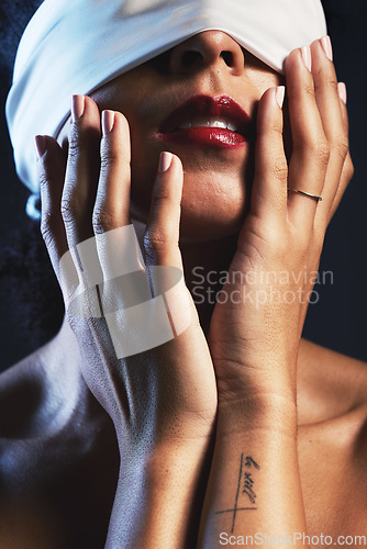 Image of Hands, blindfolded and woman in studio for creative, fashion and artistic aesthetic on black background. Model, blind and covered vintage beauty by girl model with luxury, fabric or elegant blindfold