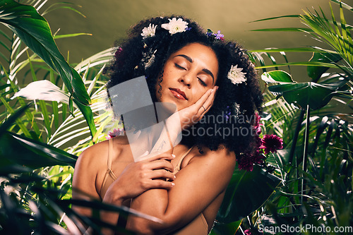 Image of Beauty, flowers and black woman in studio for wellness, skincare and creative advertising in a jungle. Facial, skin and girl model relax in zen, peace and products from nature, forest and aesthetic