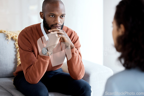 Image of Mental health, depression and black man with a therapist for grief, depression or anxiety counseling. Psychology, sad and professional psychologist helping a African male patient in a clinic session.