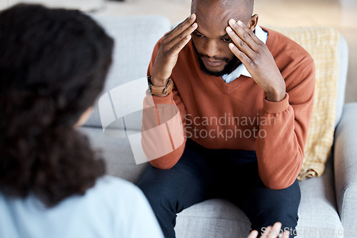 Image of Black man, mental health and headache with psychologist, stress and depression with help. Psychology consultation, woman doctor with patient and conversation about anxiety problem, sad and depressed