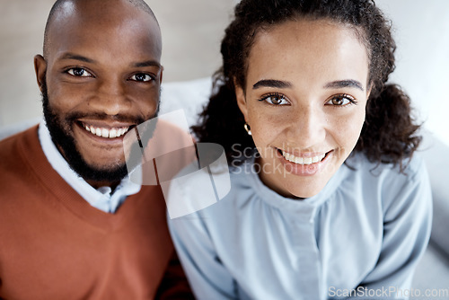 Image of Happy, smile and portrait of an interracial couple on the sofa for happiness, relax and together. Love, care and above face of a black man and woman on living room couch in a marriage for relaxing
