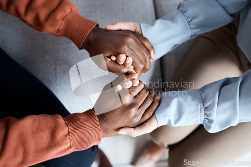 Image of Couple holding hands for support, empathy and help with news, depression or mental health problem. Therapy, psychology and depressed, sad or anxiety black man with woman hands together in counseling