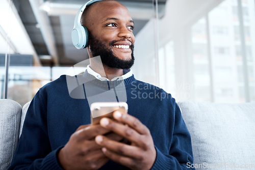 Image of Black man, face and phone with headphones for music with smile, scroll social media and audio streaming. Online, listening to radio or podcast with happiness and relax with vision and mindset
