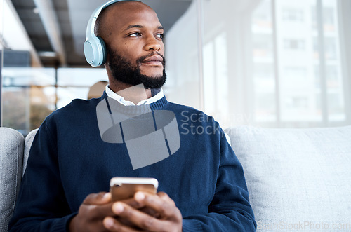 Image of Black man thinking with smartphone, headphones and music for calm and peace, vision and mindset with audio streaming. Online, listening to radio or podcast for motivation, social media and mockup