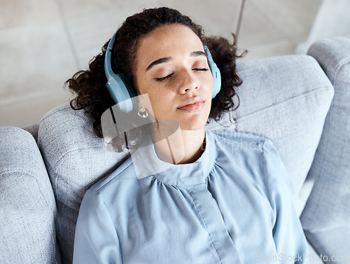 Image of Woman, face and headphones for listening to music for calm, peace and mindfulness on home couch. Young person on living room sofa listen to podcast, audio or motivation to relax or meditation above