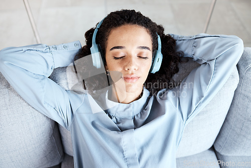 Image of Woman face, relax and headphones for listening to music for calm, peace and mindfulness. Young person on living room sofa listen to podcast, audio or motivation for meditation above home couch