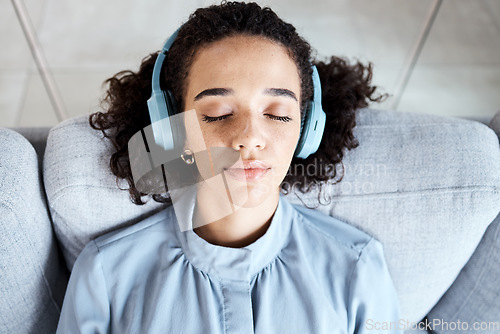 Image of Woman, face and headphones for listening to music for calm, peace and mindfulness on home couch. Young person on living room sofa listen to podcast, audio or motivation to relax or meditation above