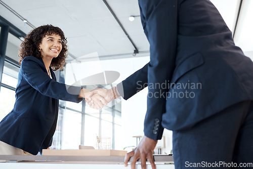 Image of Business people, handshake and smile for b2b, meeting or partnership in teamwork at the office. Happy female executive shaking hands with employee for interview, greeting or introduction at workplace