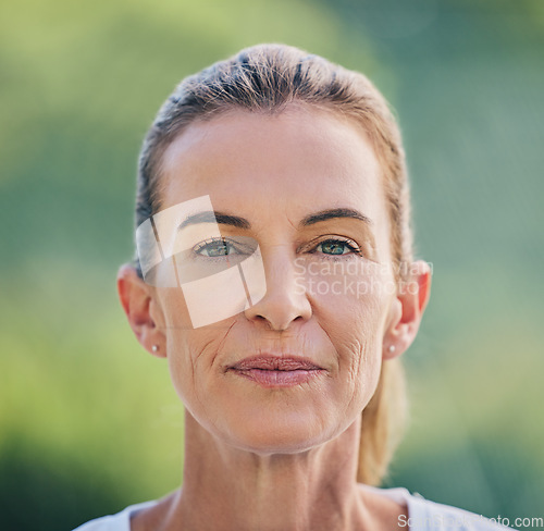 Image of Beauty, portrait and mature woman in nature for health, wellness or fresh air in summer. Beautiful, headshot and senior female model from Australia standing in a green garden, park or field.