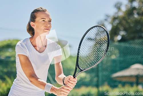 Image of Senior woman, tennis player and ready in sports game for ball, match or hobby on the court. Happy elderly female in sport fitness holding racket smiling in stance for training or practice outdoors