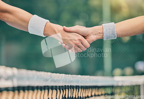 Image of Hand, tennis and handshake for partnership, trust or greeting in sportsmanship over net on the court. Players shaking hands before sports game, match or unity for deal or agreement in solidarity