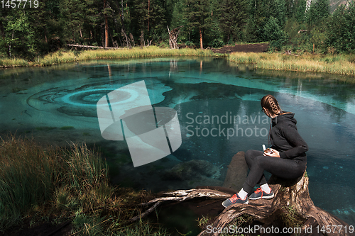 Image of Woman at Beautiful Geyser lake