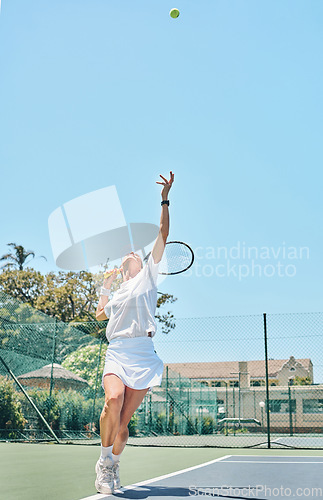 Image of Tennis serve, sports and woman on outdoor court, fitness motivation and competition with athlete training for game. Workout, healthy and player on court, active with sport and exercise with action