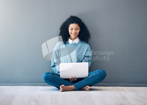 Image of Laptop, smile and search with black woman on floor for social media, news and designer on wall mockup. Website, online shopping and technology with girl for communication, internet and digital