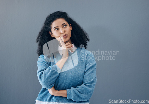 Image of Thinking, ponder and woman in a studio contemplating a question or plan in her head. Wondering, pensive and female model from Mexico brainstorming while isolated by gray background with mockup space.