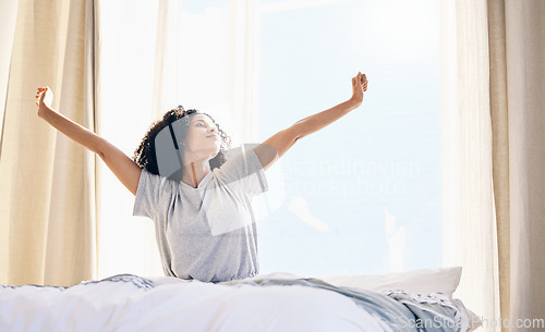 Image of Black woman, morning stretching and wake up in home bedroom after sleeping or resting. Relax, peace and comfort of young female stretch after sleep feeling fresh, awake and well rested in house.