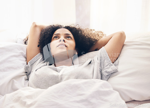 Image of Black woman, morning and thinking in home bedroom after sleeping or resting. Peace, bed relax and comfort of young female lost in thoughts, focus or contemplating ideas after waking up in house alone