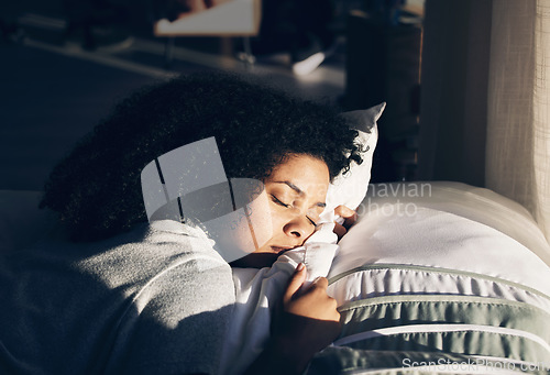 Image of Black woman, sleeping in bed for peace, quiet and rest or relax in home bedroom. Person with pillow to dream or for calm sleep with sunlight for health and wellness in apartment or hotel